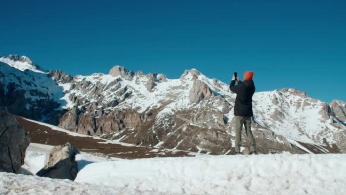 man on mountain travel using mobile phone photogra