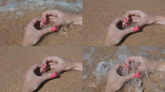 海边沙滩上女孩手中的心脏特写，度假概念