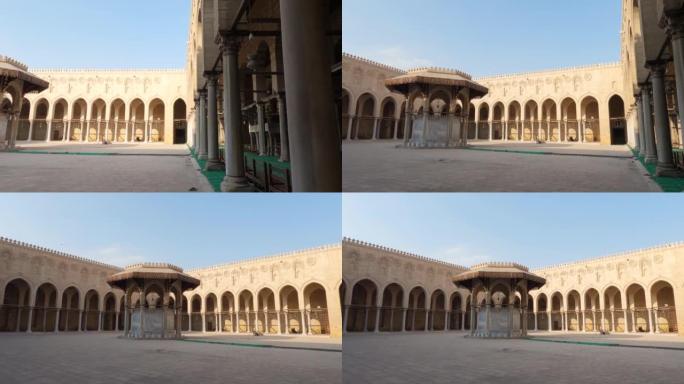 埃及开罗Sultan al-Mu'ayyad清真寺庭院中的避难所和中央喷泉。平移