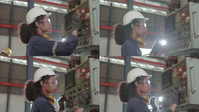 在工厂使用机械控制台面板的女工程师