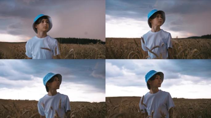 害怕的男孩站在暴风雨开始时的田野里，强风，雨前的天气，电影拍摄