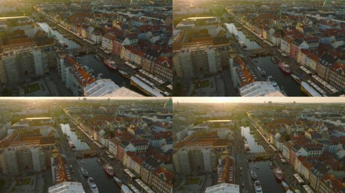 日落时尼哈文惊人的航拍画面。风景如画的旅游地标照片，码头水渠边保存着五颜六色的房屋。丹麦哥本哈根
