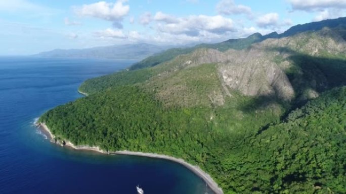 Aerial shot of a dive boat floating next to a trop