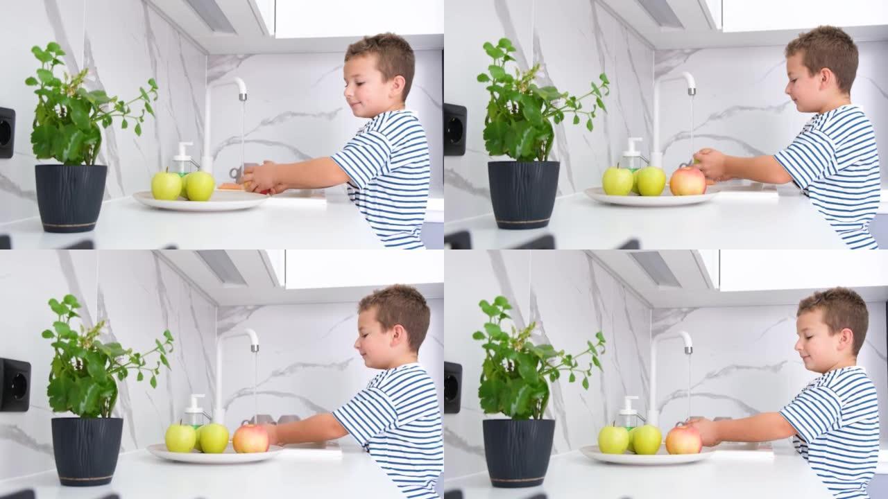 一个小男孩用自来水洗水果。健康的生活方式。个人卫生概念。