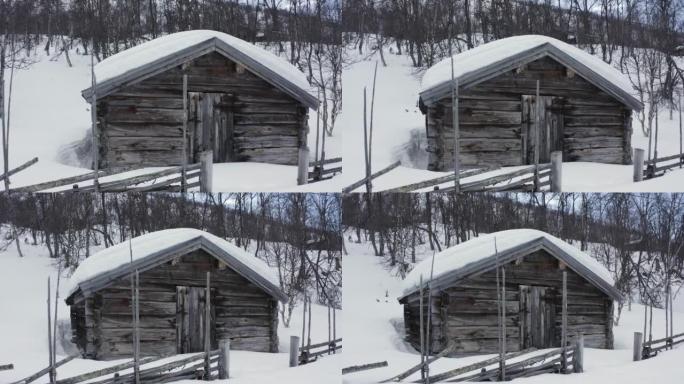 瑞典雪地中一座旧木屋的航拍画面。