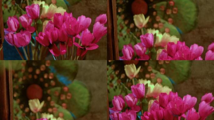 背景中粉色和米色郁金香和绿叶组成的明亮花束