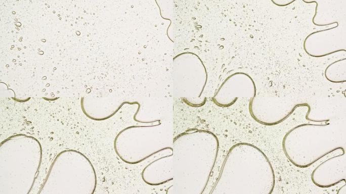 带有分子气泡油的透明化妆品凝胶液。天然有机化妆品、药物的宏观拍摄。生产特写。慢动作