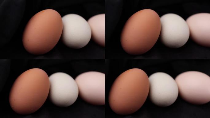 高清黑色背景下新鲜生鸡蛋的特写镜头