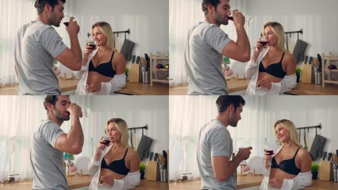 高加索年轻性感情侣叮当作响，喝了一杯啤酒。穿着黑色胸罩的迷人浪漫男人和性感女人感到快乐和放松，一起庆