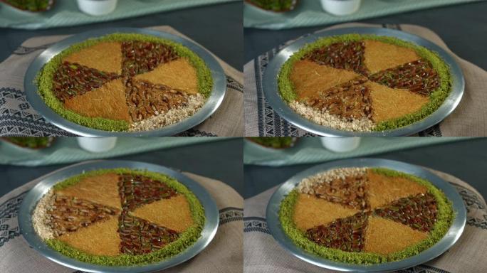 在铜板中制作传统的土耳其甜点kunefe。卡纳菲奶酪和开心果概念。