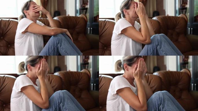 一个坐在沙发上的女人在哭，特写镜头