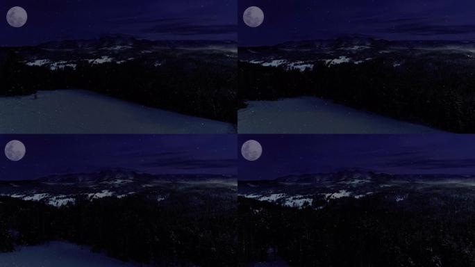 冬夜的山脉，鸟瞰图。神奇的白色冬天和闪亮的大月亮。未受破坏的冬季风景。夜晚的山路扭曲，高山史诗般的景