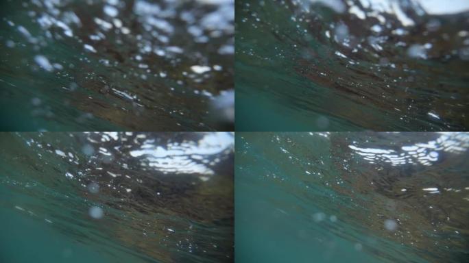 溺水。试图捕捉水面上方的空气。在水面下游泳。不同形式和形状的气泡在水中。