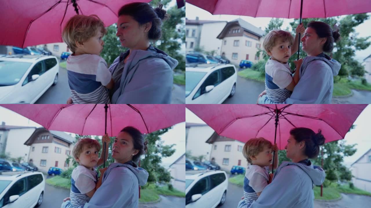 雨天，母子在伞下。父母和小男孩防雨