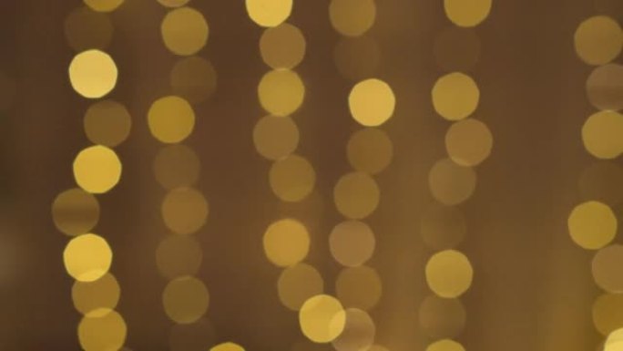 圣诞闪烁抽象金色圆圈散焦灯光背景