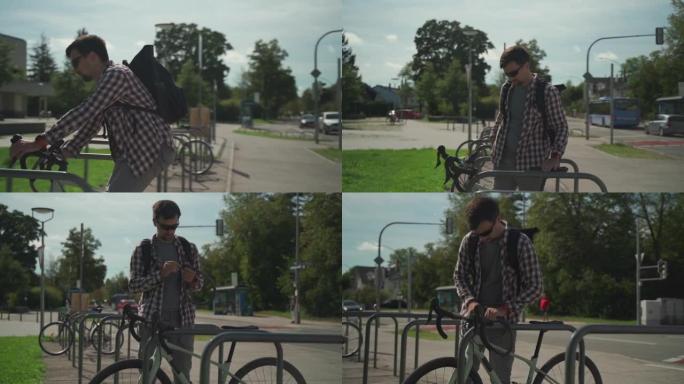 自行车的安全和防盗锁。男性自行车手将自行车锁在德国欧洲城市的街头自行车停车场。盖伊 (Guy) 固定