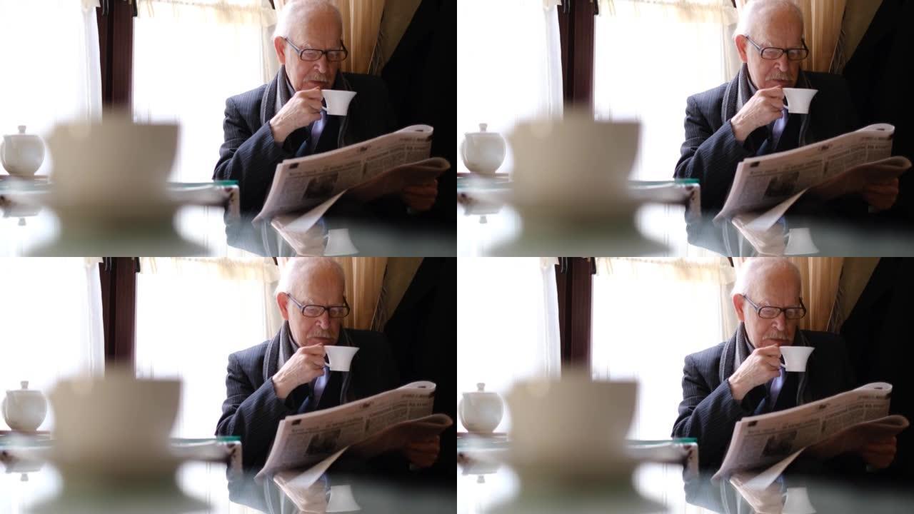 老人在餐桌上阅读报纸的最新消息，养老金领取者休息并喝茶