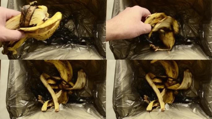 一名男子将香蕉皮扔进垃圾垃圾中。浪费食物概念