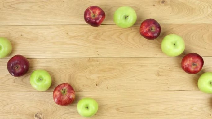 红色美味和奶奶史密斯苹果的停止运动。平坦层。健康食品和多汁水果概念，在桌子上旋转