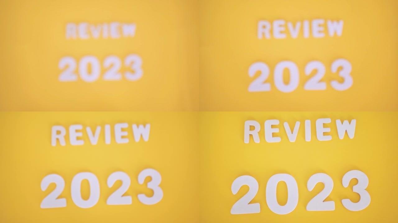 题词评论2023在黄色背景上，从上方拍摄，从模糊到清晰图像的过渡