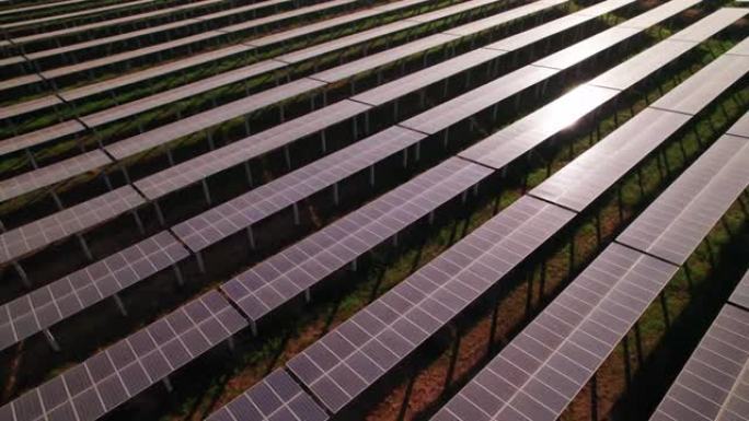 对称太阳能电池板农场的一排的鸟瞰图，用于收集从太阳吸收能量并将其转化为电能的光伏 (PV) 太阳能电