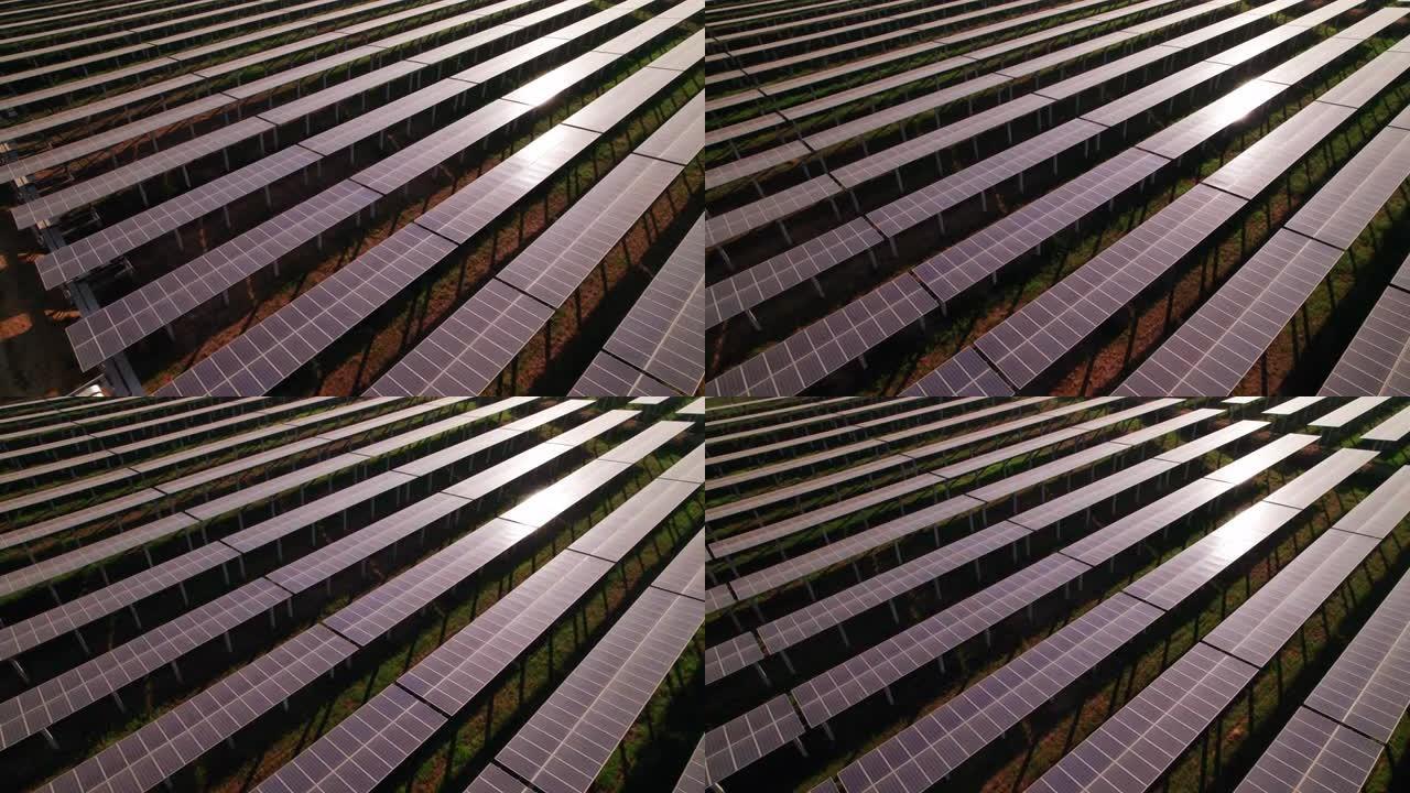 对称太阳能电池板农场的一排的鸟瞰图，用于收集从太阳吸收能量并将其转化为电能的光伏 (PV) 太阳能电