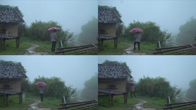 在暴雨中撑伞行走的人