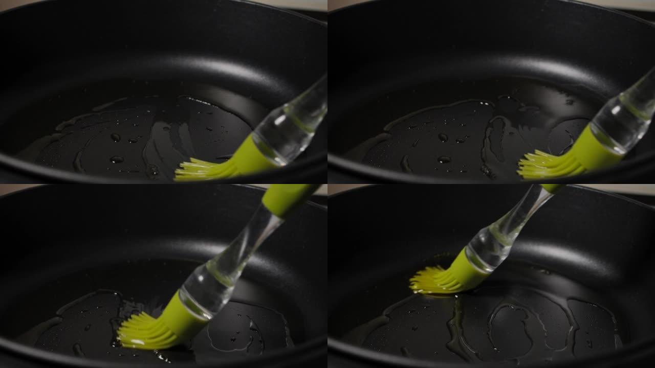 慢动作男子将橄榄油从瓶中润滑到煎锅中，特写镜头。宏观射击厨师将植物油润滑到煎锅中，以进行慢动作烹饪。