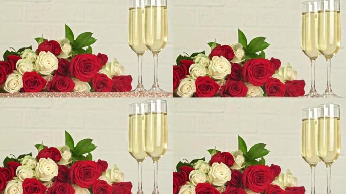香槟酒杯和白色背景上的红色，白色玫瑰花束
