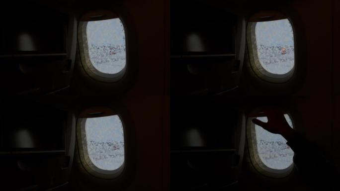 4k稳定的镜头显示，飞机的照明器在外面恶劣的冬季天气被关闭，为长途长途飞行做准备。