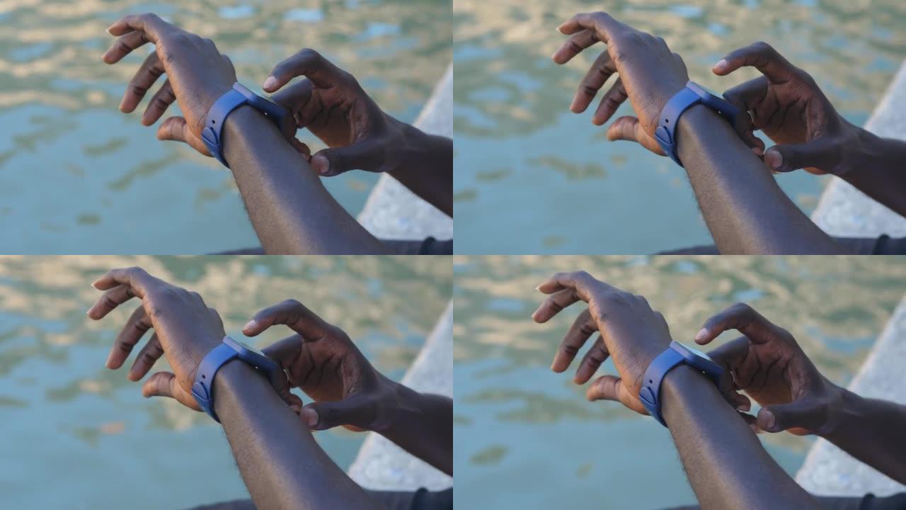 黑人使用她的智能手表触摸屏可穿戴技术设备