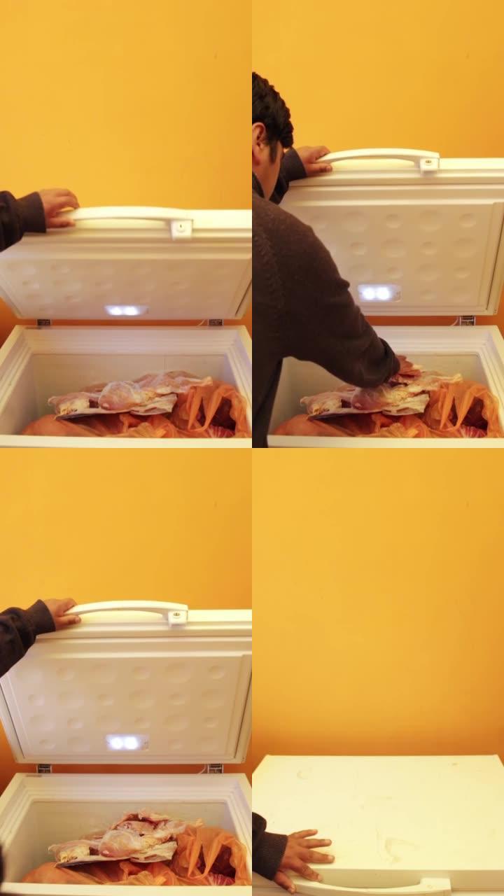 一名拉丁男子将鸡块放在橙色墙壁上的白色冰箱中