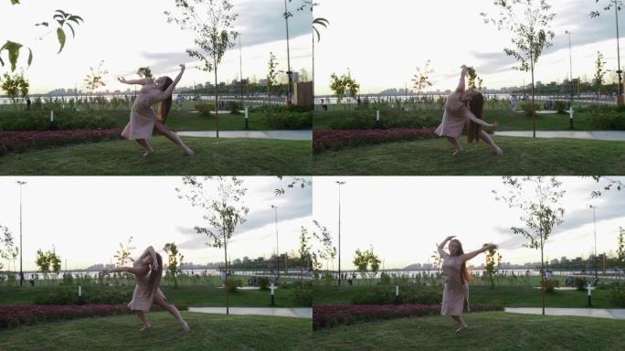 穿着米色连衣裙的女人在公园的草地上跳舞，赤脚慢动作