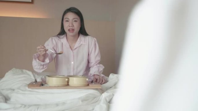 东南亚女人在床上吃早餐