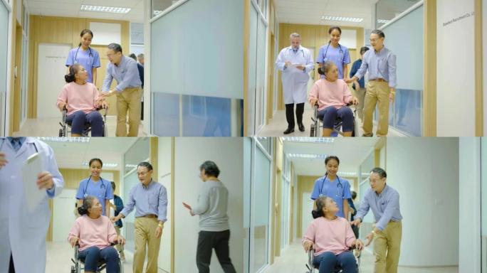成熟的男人照顾轮椅上的老妇人。护士在医院走廊上推着轮椅与女性老年患者的前视图。丈夫支持高级残疾妻子