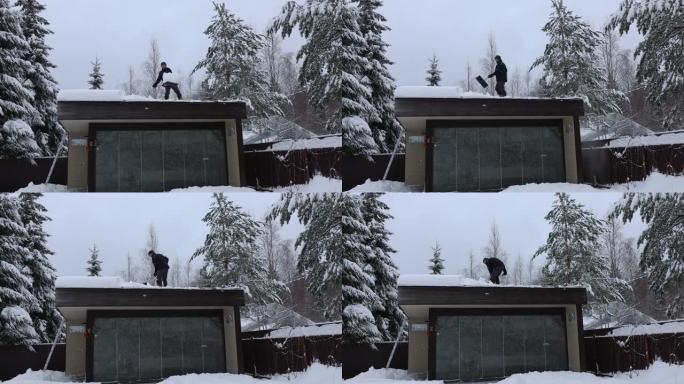 在冬季霜冻的日子里，男人用铁锹从房屋屋顶，公寓楼打扫雪。