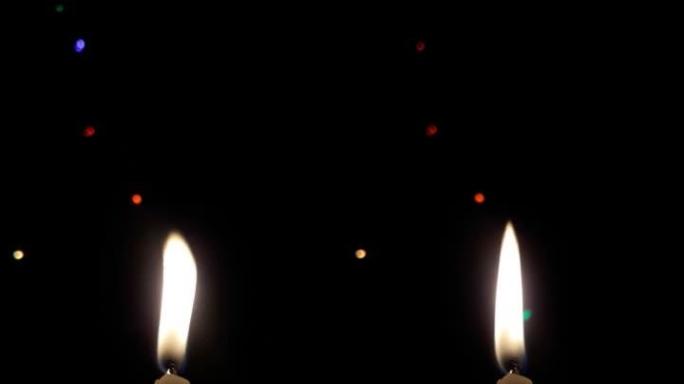 蜡蜡烛在夜晚节日闪烁的灯光模糊的背景下燃烧着明亮的火焰。