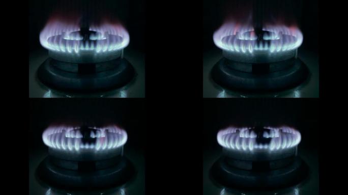 蓝色厨房燃气灶火与亮橙色闪光减少。经济制裁和危机概念
