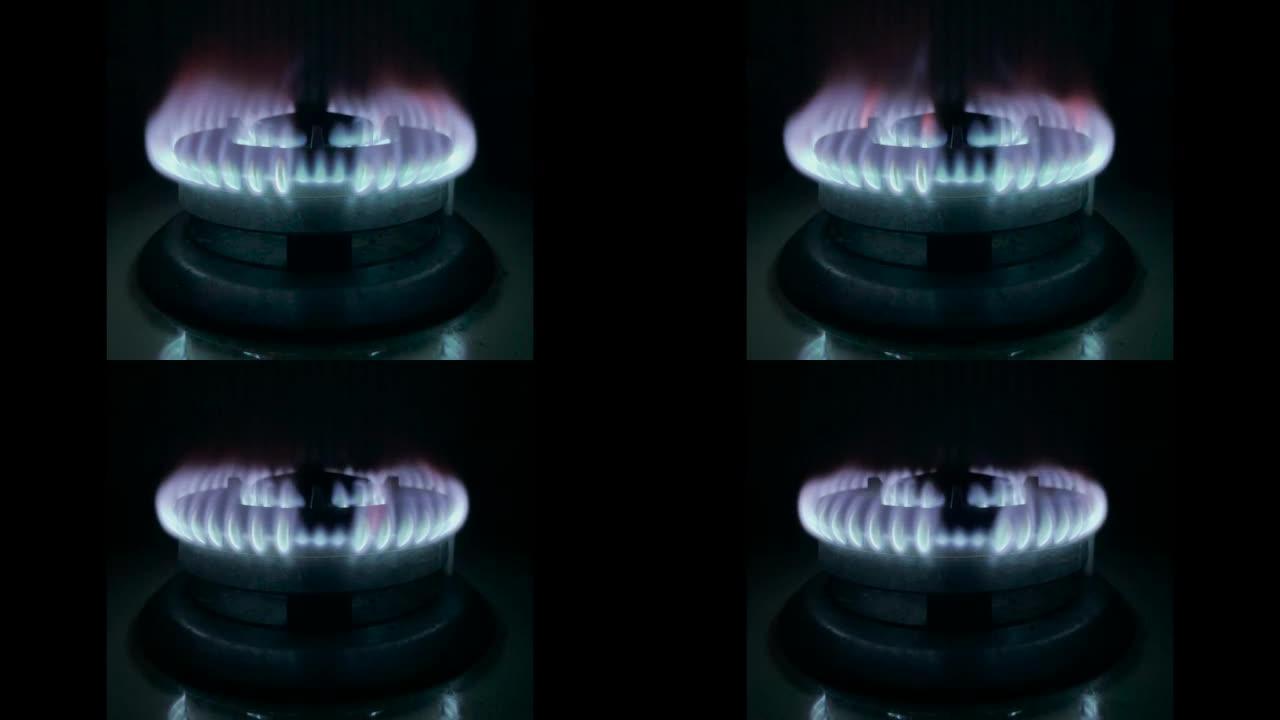 蓝色厨房燃气灶火与亮橙色闪光减少。经济制裁和危机概念