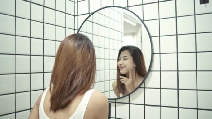 女人在浴室里看着镜子。