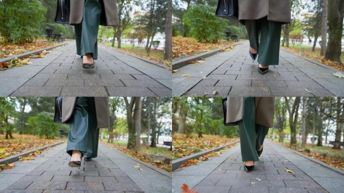 在阴云密布的秋日，穿着高跟鞋的美腿女商人走在路上