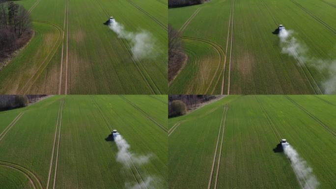 农用拖拉机在春季麦田上撒肥，空中