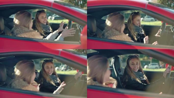 漂亮的女人在红色跑车内聊天，两个女性朋友准备周末旅行和娱乐，迷人的年轻女人在开着窗户的车内听音乐，说