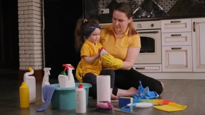 一位母亲和一个小女儿在打扫卫生时在家玩耍的特写镜头。