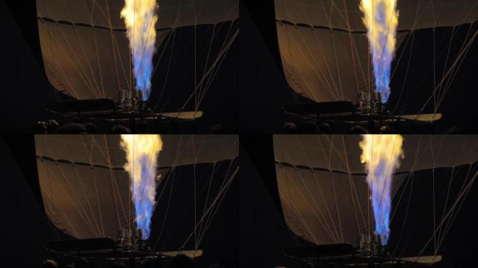 气球在夜间充气飞行时的特写镜头，燃烧燃烧器的火焰