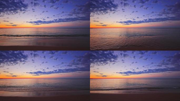 海沙和孤岛海滩上的日出。灼热的太阳正从海浪中升起。