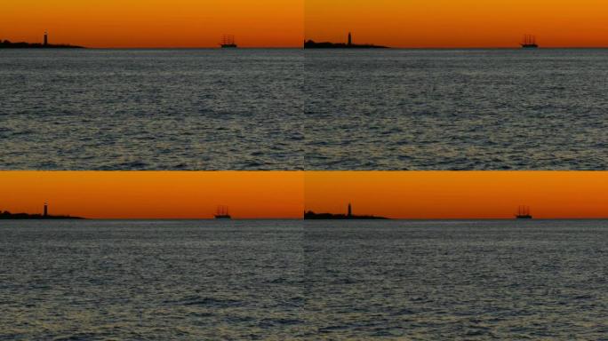 日落时高大的船在大海和灯塔