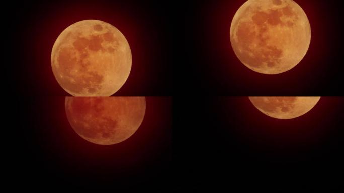 红色的月亮在红色的天空中移动，乌云覆盖着月亮