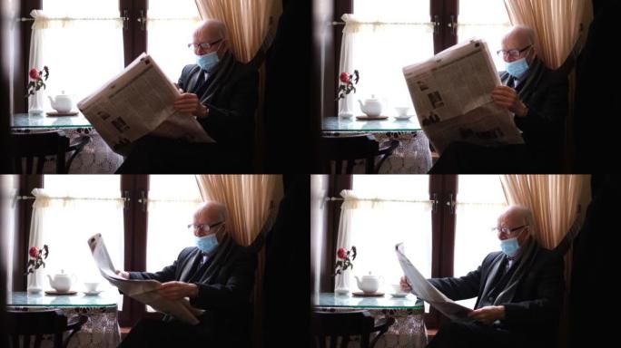 戴眼镜的白发祖父读一份新鲜报纸，喝咖啡
