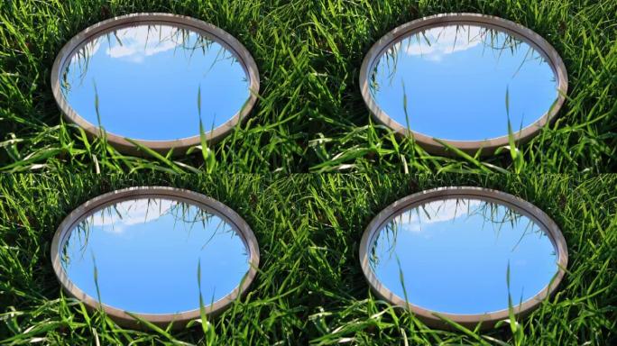 多云的蓝天反射在夏天的草地上的圆形木镜中。自然概念。地球日。节省环境。和平。生态保护。气候变化、全球